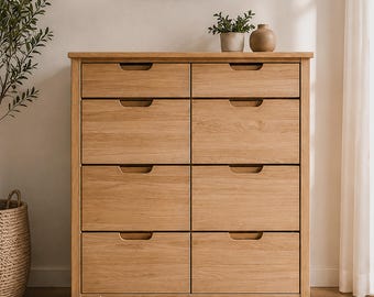 May include: A light oak wooden dresser featuring eight drawers arranged in two vertical columns. Each drawer has a semi-circular cutout handle. The text WoodYouAdore | Catania is printed in white at the bottom center of the furniture piece.