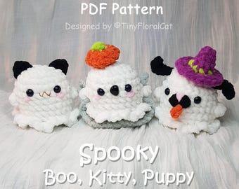 May include: Three handmade crochet ghost figures. One is a panda, one has a pumpkin on its head, and the third is a puppy with a witch hat. The text on the image says "Spooky Boo, Kitty, Puppy".
