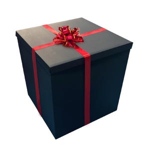 May include: A large black gift box with a red ribbon and bow. The box is tied with a red ribbon and bow.