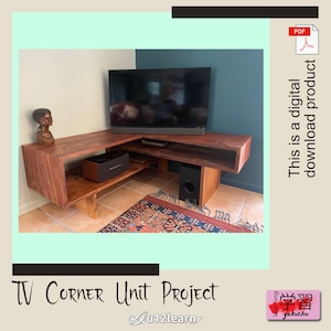 May include: A wooden corner TV unit with a dark brown stain. The unit has two shelves and a cutout for a TV. There is a small speaker on the top shelf and a larger speaker on the bottom shelf. The unit is in a room with a light blue wall and a dark blue wall.