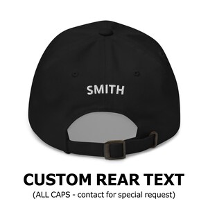 May include: Black baseball cap with a white embroidered text "SMITH" on the back. The cap has an adjustable strap.