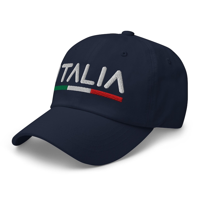 May include: A navy blue baseball cap with white embroidered text that reads "ITALIA" and a small Italian flag above the text.