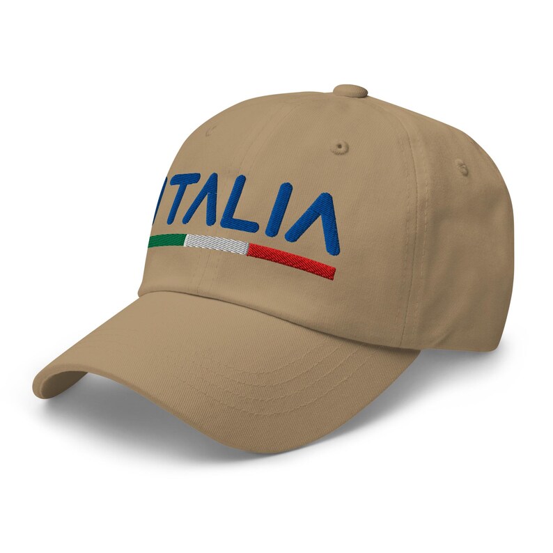 May include: A tan baseball cap with the word "ITALIA" embroidered in blue with a green, white, and red stripe underneath.