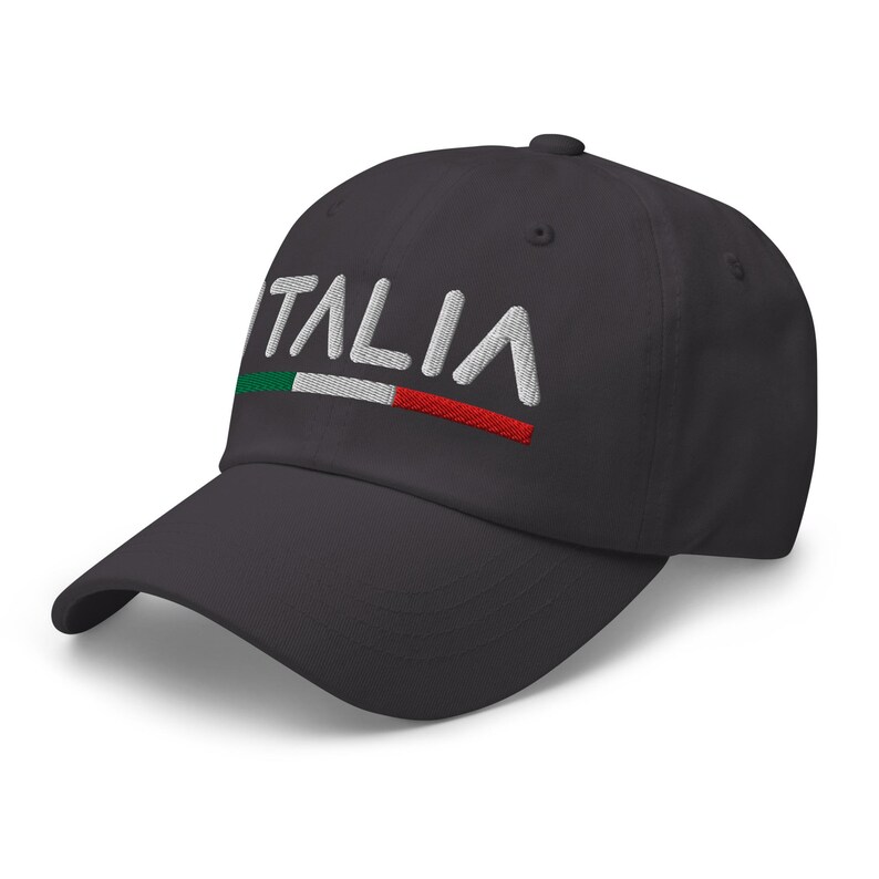 May include: A dark gray baseball cap with the word "ITALIA" embroidered in white with a green, white, and red stripe underneath.