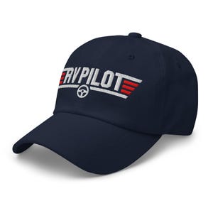 May include: Navy blue baseball cap with white embroidery that reads "RV PILOT" with a red and white wing design.