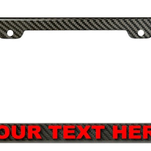 May include: Black carbon fiber license plate frame with red text that says "YOUR TEXT HERE".