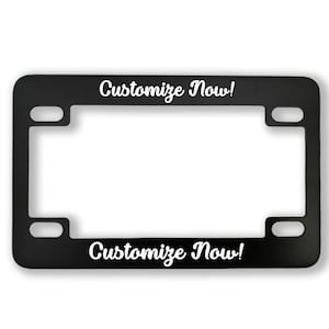May include: Black metal license plate frame with the text "Customize Now!" printed in white on the top and bottom.