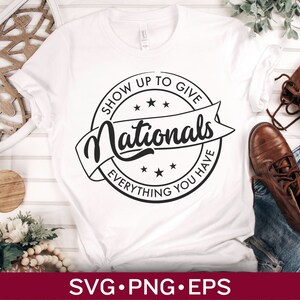May include: White t-shirt with a black and white graphic design of a circle with the text "Show Up To Give Nationals Everything You Have".