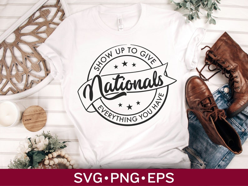 May include: White t-shirt with a black and white graphic design of a circle with the text "Show Up To Give Nationals Everything You Have".