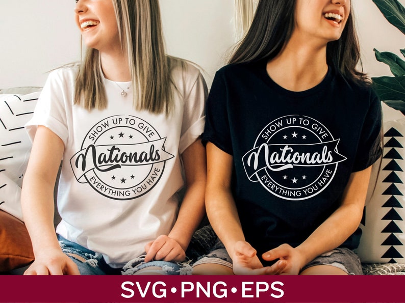 May include: Two women wearing white and black t-shirts with a black and white circular design that says "Show Up To Give Nationals Everything You Have".