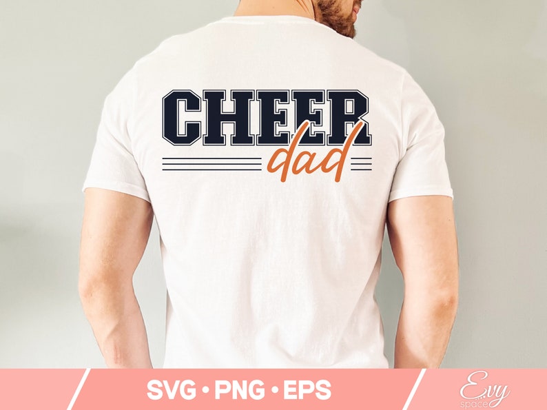 May include: White t-shirt with the text "CHEER dad" in black and orange lettering. The text is in a varsity style font.