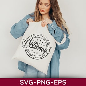 May include: A white tote bag with a black circle design that says "Show Up To Give Everything You Have Nationals".