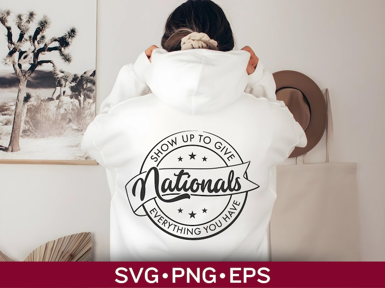 May include: White hoodie with a black and white circular design that says "Show Up To Give Nationals Everything You Have".
