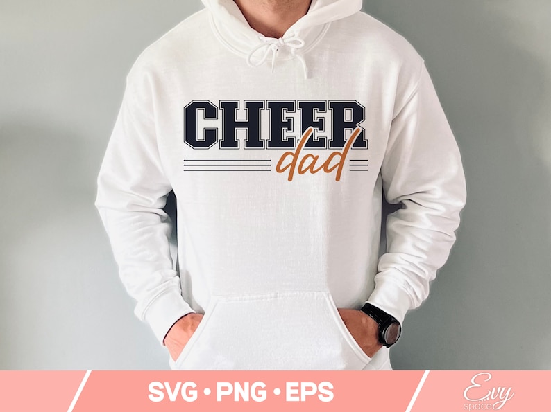 May include: White hoodie with the text "CHEER dad" in black and orange lettering. The text is in a varsity style font.