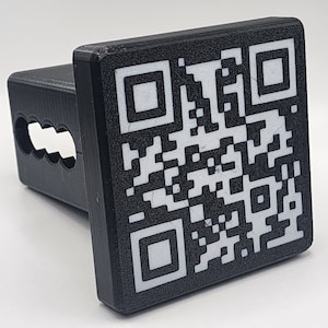 May include: Black plastic hitch cover with a white QR code printed on it.