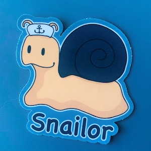 May include: A sticker featuring a cartoon snail wearing a sailor hat with an anchor emblem. The snail has a tan body, a dark blue shell, and the word "Snailor" in blue text. The sticker has a light blue border and is set against a blue background.