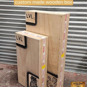 May include: Two custom-made wooden boxes, one large and one small, are shown. The boxes are made of light-colored wood and feature black stenciled designs and the text "LVL". The boxes are sealed with "Fragile" tape.