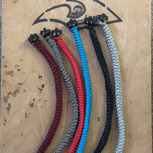 May include: Five different colored braided rope leashes with black metal clips and swivels. The leashes are burgundy, black and white, red, blue, and gray and white.