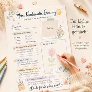May include: A white paper kindergarten memory sheet with pastel illustrations of a sun, flowers, and leaves. It features sections for a name, photo, drawings, and handwritten text in German, including prompts for favorite activities and school memories.