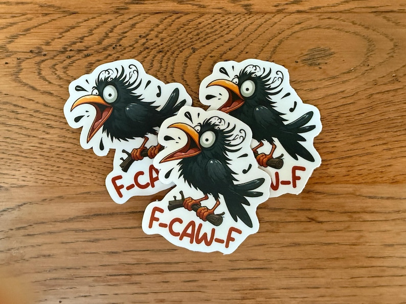 May include: Three stickers featuring a cartoon crow with an open beak, perched on a branch. The crow is black with a yellow beak and is surrounded by musical notes. The text "F-CAW-F" is printed on the sticker.