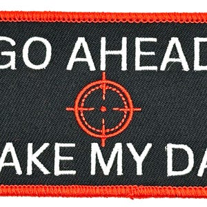 May include: Black and red embroidered patch with the text "GO AHEAD MAKE MY DAY" and a red target symbol in the centre.