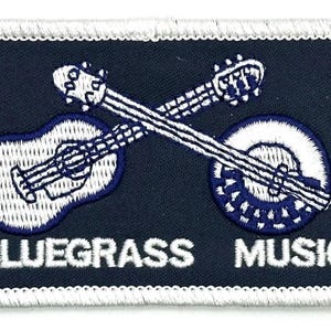 May include: Embroidered patch with a navy background, featuring a white and blue banjo and guitar crossed over each other. The words "BLUEGRASS MUSIC" are embroidered in white.