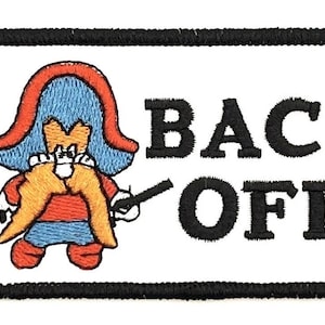 May include: Embroidered patch featuring a cartoon character in red and blue, holding two black sticks. The words "BACK OFF" are in bold black letters on a white background, with a black border.