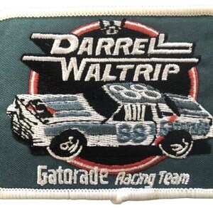 May include: Embroidered patch featuring a race car with the number 88, the name "Darrell Waltrip," and the text "Gatorade Racing Team." The patch has a teal background with white and black details and a white border.