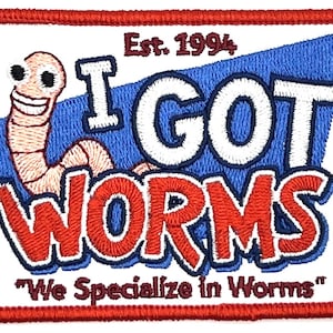 May include: Embroidered patch with a red border and a white background. The patch features a smiling cartoon worm and the text "I GOT WORMS" in white and red lettering. The text "Est. 1994" and "We Specialize in Worms" are also included.