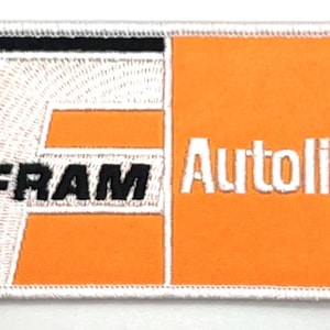 May include: A white and orange embroidered patch with the words "FRAM" and "Autolite" in white lettering.