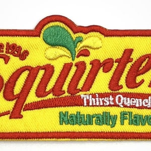 May include: A yellow and red embroidered patch with the words "Squirt" in red, "Since 1950" in white, "Thirst Quencher" in white, and "Naturally Flavored" in green.