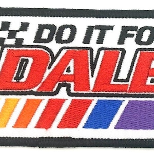 May include: Embroidered patch with the text "DO IT FOR DALE" in black and red. The patch features a checkered flag design and a colorful stripe pattern in yellow, orange, red, blue, and purple.