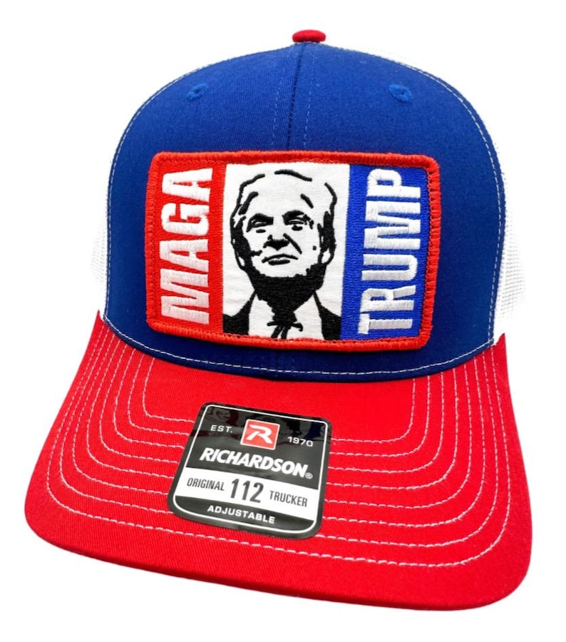 May include: A blue, white, and red trucker hat with a red, white, and blue patch that says "MAGA TRUMP" and a picture of Donald Trump. The hat is adjustable and has a Richardson 112 label.