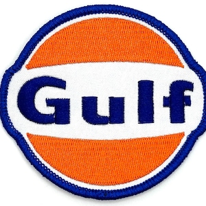 May include: A blue and orange embroidered patch with the word "Gulf" in blue lettering.