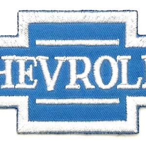 May include: A blue and white embroidered patch with the word "CHEVROLET" in white lettering.