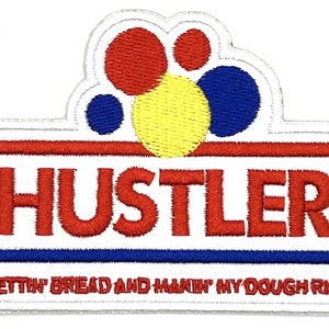 May include: White embroidered patch with a red, yellow and blue circle design. The text "Hustler" is in red and the text "Gettin' Bread and Makin' My Dough Rise" is in black.