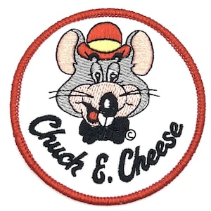 May include: Embroidered patch featuring Chuck E. Cheese, a cartoon mouse wearing a hat. The patch is circular, with a white background and a red stitched border. The text "Chuck & Cheese" is in black.