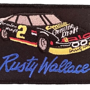 May include: Black embroidered patch featuring a racing car with the number 2 and the text "Miller Genuine Draft" on the side. The car is on a black background with the signature "Rusty Wallace" in blue below.