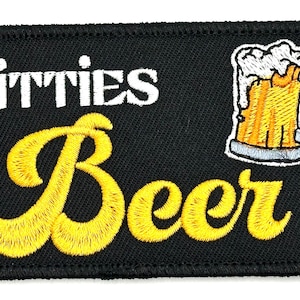 May include: Black embroidered patch with white text that reads "TITTIES & Beer" and a yellow embroidered beer mug with foam on top.