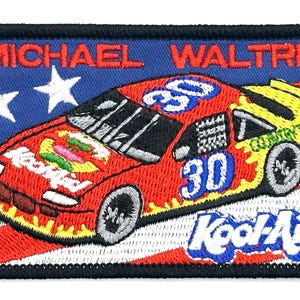 May include: Embroidered patch featuring a red race car with the number 30, the Kool-Aid logo, and the name Michael Waltrip. The background includes a blue section with two white stars and a red and white striped section.