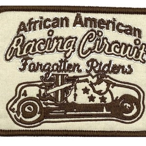 May include: A brown embroidered patch with a white background. The patch features a vintage race car with the text "African American Racing Circuit Forgotten Riders".