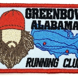 May include: Embroidered patch with a cartoon of a man with a beard and a red hat, a map of the United States with red dots, and the text "GREENBOW ALABAMA RUNNING CLUB".