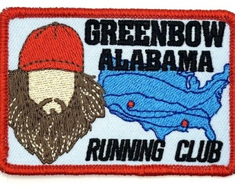 May include: Embroidered patch with a cartoon of a man with a beard and a red hat, a map of the United States with red dots, and the text "GREENBOW ALABAMA RUNNING CLUB".
