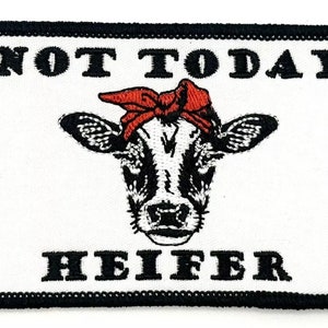 May include: White embroidered patch with a black border. The patch features a black and white cow with a red bandana and the text "NOT TODAY HEIFER".