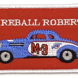 May include: Embroidered patch featuring a vintage race car design. The patch has a red background with the words "FIREBALL ROBERTS" in white. The car is blue and white with the number "M-3".