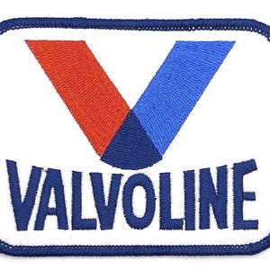 May include: Embroidered patch with the Valvoline logo. The patch has a white background and a blue border. The logo features a red and blue V-shape and the word "VALVOLINE" in blue.