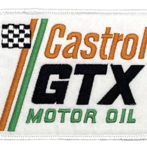 May include: White embroidered patch with green and orange stripes, a checkered flag, and the text "Castrol GTX Motor Oil".