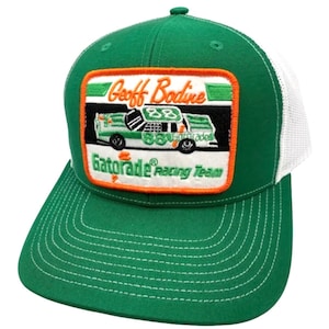 May include: Green and white trucker hat with a patch featuring a race car and the text "Geoff Bodine Gatorade Racing Team".