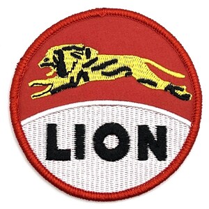 May include: Embroidered patch with a red circular border. The patch features a yellow lion with black stripes leaping across a red background. The word "LION" is embroidered in black on a white background.