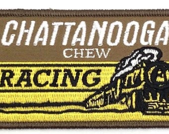May include: A rectangular patch with the words "CHATTANOOGA CHEW RACING" in white and black lettering. The patch features a brown background with a yellow stripe and a black and white illustration of a train.